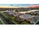 An aerial view of a luxurious neighborhood highlighting homes with pools and waterfront views at 8195 Redonda Loop, Lakewood Ranch, FL 34202