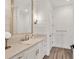 Charming bathroom with a stone counter vanity, wood plank accent wall, and modern fixtures at 8195 Redonda Loop, Lakewood Ranch, FL 34202