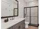 Modern bathroom featuring a glass enclosed shower, white vessel sink, and plank accent wall at 8195 Redonda Loop, Lakewood Ranch, FL 34202