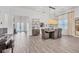Elegant dining room with stylish chandelier, modern furniture, and views of the front entryway at 8195 Redonda Loop, Lakewood Ranch, FL 34202