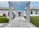 Covered walkway leading to the clubhouse, showcasing beautiful stonework, landscaping and manicured lawns at 8195 Redonda Loop, Lakewood Ranch, FL 34202