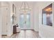Bright foyer featuring elegant lighting, shiplap walls, and light wood floors at 8195 Redonda Loop, Lakewood Ranch, FL 34202