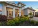 Inviting single-story home featuring a covered porch and lush landscaping at 8195 Redonda Loop, Lakewood Ranch, FL 34202
