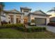 Well-maintained single-story home with landscaped yard and inviting covered porch at 8195 Redonda Loop, Lakewood Ranch, FL 34202