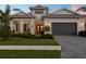Beautiful single-story home with a well manicured lawn, a gray roof, and a gray two car garage at 8195 Redonda Loop, Lakewood Ranch, FL 34202