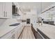 Gourmet kitchen with white cabinetry, stainless steel appliances, a gas cooktop and an island with a farmhouse sink at 8195 Redonda Loop, Bradenton, FL 34202