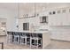 Bright kitchen with quartz countertops, white cabinets, and an island with stool seating at 8195 Redonda Loop, Bradenton, FL 34202