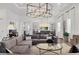 Sophisticated living room featuring stylish decor and views into the dining area at 8195 Redonda Loop, Lakewood Ranch, FL 34202