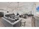 Open-concept living room with comfortable seating and views into the kitchen and dining areas at 8195 Redonda Loop, Lakewood Ranch, FL 34202