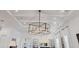 Elegant lighting fixture, coffered ceiling, and open layout in the living room at 8195 Redonda Loop, Lakewood Ranch, FL 34202