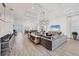 Expansive living area with modern furnishings and seamless flow to the dining and kitchen at 8195 Redonda Loop, Lakewood Ranch, FL 34202