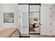 Spacious bedroom showcasing a sliding glass door entrance into the Primary bathroom with tiled floors and shower at 8195 Redonda Loop, Lakewood Ranch, FL 34202