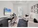 Modern office space with desk, seating, and tv with an ensuite bathroom at 8195 Redonda Loop, Lakewood Ranch, FL 34202