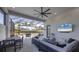 Entertain in this outdoor living space with comfortable seating, a TV, and view of the pool at 8195 Redonda Loop, Lakewood Ranch, FL 34202