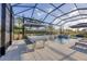 Relax by the pool and hot tub in this screened-in lanai featuring a private waterfall feature at 8195 Redonda Loop, Lakewood Ranch, FL 34202