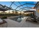 Enjoy warm evenings by this pool boasting a spa, waterfall, and screened-in lanai at 8195 Redonda Loop, Lakewood Ranch, FL 34202