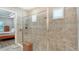 Bathroom showcasing a glass-enclosed shower with tiled walls and a built-in bench at 8713 Mangilli Rd, Sarasota, FL 34238