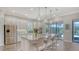 Modern kitchen island with stainless steel appliances, granite counters, pendant lights, and a view to the pool at 8713 Mangilli Rd, Sarasota, FL 34238