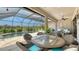 Wide angle view of screened-in pool patio with outdoor dining, seating, grill, and water feature in the swimming pool at 8713 Mangilli Rd, Sarasota, FL 34238