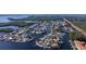 Aerial view of waterfront homes with docks and canal access, surrounded by lush greenery and situated in a desirable neighborhood at 10108 Kingfisher E Rd, Bradenton, FL 34209