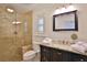 Elegant bathroom with a glass-door shower and dark wooden cabinets at 10108 Kingfisher E Rd, Bradenton, FL 34209