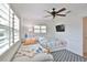 Bright bedroom with two twin beds, a ceiling fan and light-colored flooring at 10108 Kingfisher E Rd, Bradenton, FL 34209