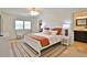 Bright bedroom with an ensuite bathroom, a large bed, and neutral tones at 10108 Kingfisher E Rd, Bradenton, FL 34209