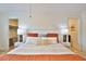 Bright bedroom with a white bedframe and two doorways to an ensuite and closet at 10108 Kingfisher E Rd, Bradenton, FL 34209