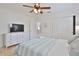 Bedroom featuring ceiling fan, tv, and view to sitting room at 10108 Kingfisher E Rd, Bradenton, FL 34209