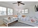 Bedroom featuring a ceiling fan, two windows, and a unique bed design at 10108 Kingfisher E Rd, Bradenton, FL 34209