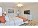 Bedroom featuring a light-colored bed set, a dresser, and light tile flooring at 10108 Kingfisher E Rd, Bradenton, FL 34209