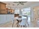 Dining area adjacent to kitchen, showcasing a modern round table with white chairs and a ceiling fan at 10108 Kingfisher E Rd, Bradenton, FL 34209