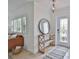 Inviting foyer features tile flooring, decorative mirror, console table, and natural light from the front door at 10108 Kingfisher E Rd, Bradenton, FL 34209