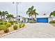 Beautifully landscaped single Gathering home with large driveway, blue shutters and garage door at 10108 Kingfisher E Rd, Bradenton, FL 34209