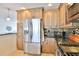 Bright kitchen features stainless steel refrigerator, modern appliances, granite countertops, and custom cabinets at 10108 Kingfisher E Rd, Bradenton, FL 34209