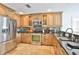 Well-equipped kitchen featuring stainless steel appliances, granite countertops, and custom cabinetry with glass accents at 10108 Kingfisher E Rd, Bradenton, FL 34209
