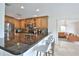 Well-lit kitchen with stainless steel appliances, bar seating, and granite countertops at 10108 Kingfisher E Rd, Bradenton, FL 34209