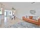Open-concept layout: living area flows into dining space, featuring tile floors and a comfortable sofa at 10108 Kingfisher E Rd, Bradenton, FL 34209