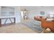 Open-concept living room with tile floors, leather furniture, and tasteful décor, leading into dining area at 10108 Kingfisher E Rd, Bradenton, FL 34209