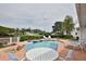 Beautiful pool area featuring a spa, lush landscaping, and ample seating at 10108 Kingfisher E Rd, Bradenton, FL 34209