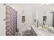 Bathroom with a shower and tub, a single sink vanity, and purple decor at 10819 Wicker Park Pl, Palmetto, FL 34221