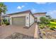 Elegant single-story home with a tile roof, two car garage, beautiful landscaping, and paved walkway at 10819 Wicker Park Pl, Palmetto, FL 34221