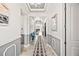 Hallway has marble floors, custom wainscoting, detailed ceilings, and an open view to the living room at 10819 Wicker Park Pl, Palmetto, FL 34221
