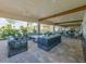 Inviting outdoor seating area with comfortable sofas and ceiling fans, perfect for relaxation and entertaining at 10819 Wicker Park Pl, Palmetto, FL 34221