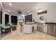 Outdoor kitchen with stainless steel grill, bar seating, and TV, perfect for entertaining at 10819 Wicker Park Pl, Palmetto, FL 34221