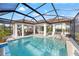 Beautiful screened-in pool area featuring ample seating, a well-kept pool, and tiled floors perfect for entertaining at 10819 Wicker Park Pl, Palmetto, FL 34221
