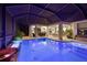 Beautiful covered outdoor pool area complete with outdoor kitchen, bar seating, and entertainment area at 10819 Wicker Park Pl, Palmetto, FL 34221