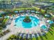 Stunning aerial view of a circular pool with lush landscaping and lounge chairs, creating a resort-style oasis at 10819 Wicker Park Pl, Palmetto, FL 34221