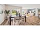 Dining area featuring table with six chairs, wood floors, and sliding glass doors to outdoor area at 10844 Gentle Current Way, Parrish, FL 34219