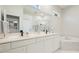 Bright bathroom features double sinks, vanity and a view of the bathtub and corner shower at 11116 Sanctuary Dr, Bradenton, FL 34209